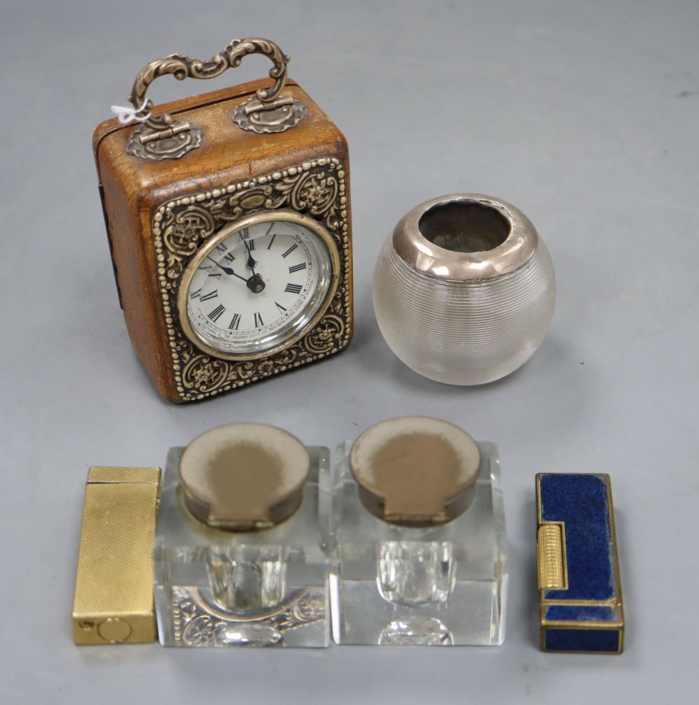 A small American travel clock in leather silver mounted case, two dunhill lighters, a glass striker and two inkwells